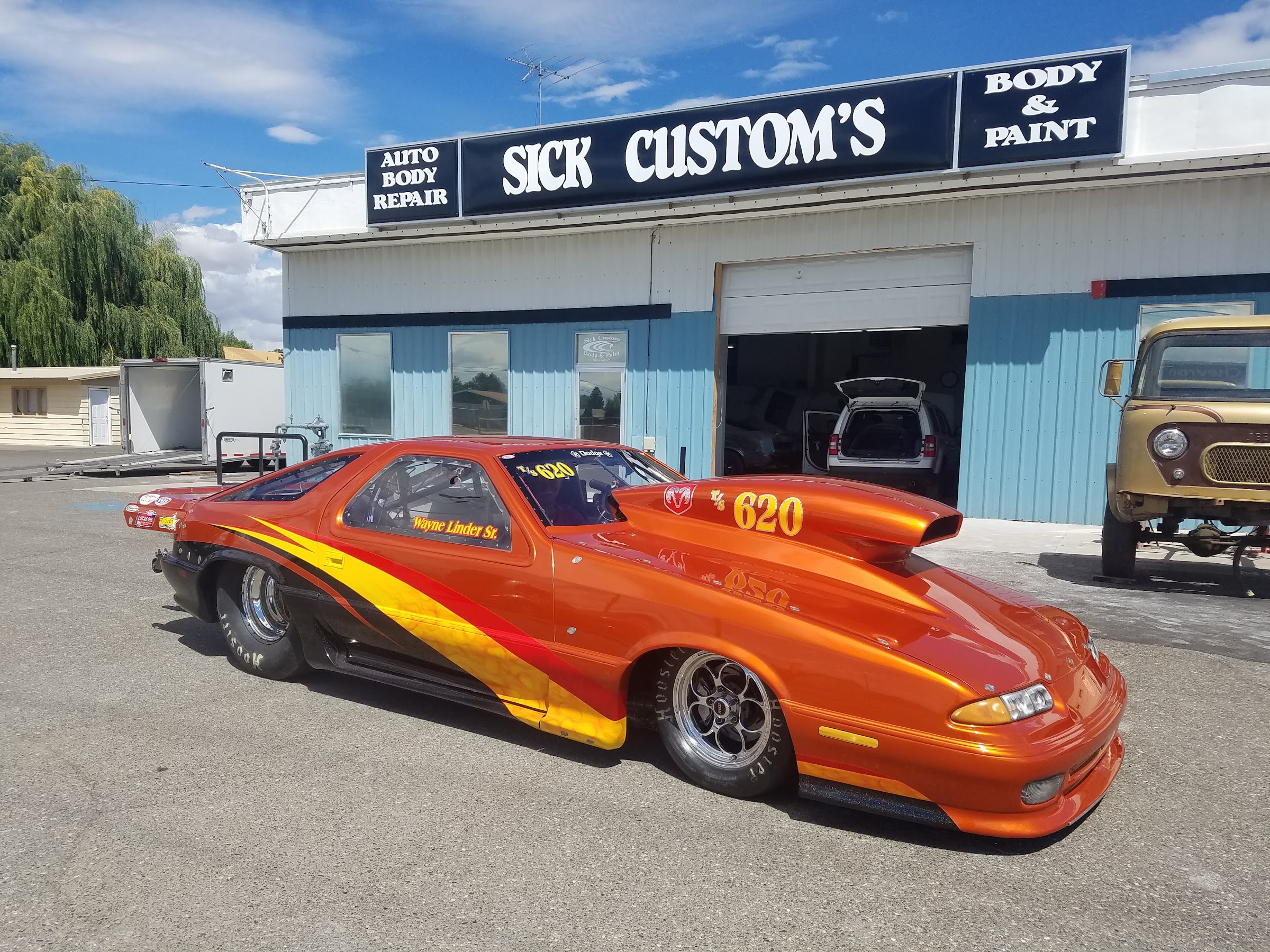 A drag car with a custom orange and yellow flame paint job built at Sick Custom Collision Repair